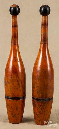 Pair of wooden Indian clubs, ca. 1900, with remnants of a red wash, 14 1/2'' h.