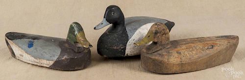 Three carved and painted duck decoys, 20th c., to include a bluebill with a cork body