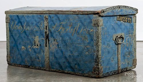 Painted pine immigrant's trunk, dated 1868, retaining an old blue surface, 18 1/4'' h., 37'' w.