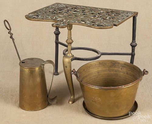 Brass and iron fireplace trivet, 19th c., 11 3/4'' h., 10'' w., together with a brass kettle, 5 1/4'' h.