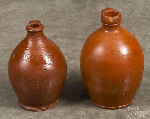 Two Pennsylvania redware jugs, 19th c., 7'' h. and 8'' h.