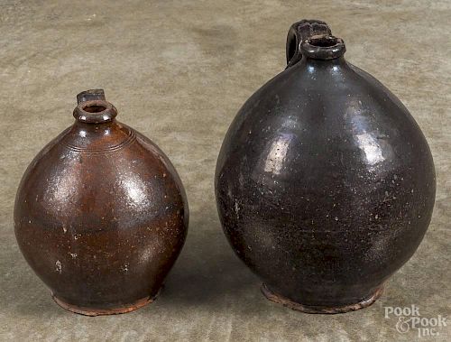 Two redware ovoid jugs, 19th c., 7 3/4'' h. and 10'' h.