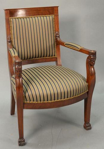 Mahogany upholstered armchair with carved Egyptian Pharaoh arms on claw feet.