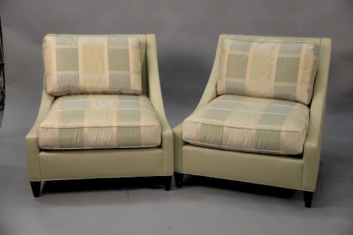 Pair of Baker upholstered club chairs having silk upholstered cushions.