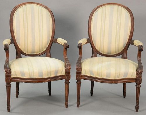 Pair of Louis XVI French style upholstered armchairs with oval backs.