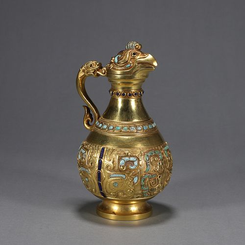 A gem-inlaid gold phoenix head pot