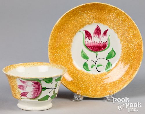 Yellow spatter cup and saucer with tulip.