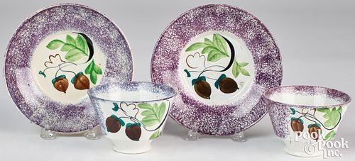 Two purple spatterware acorn cups and saucers