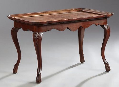 Carved Walnut Coffee Table, c. 1930, the serpentin