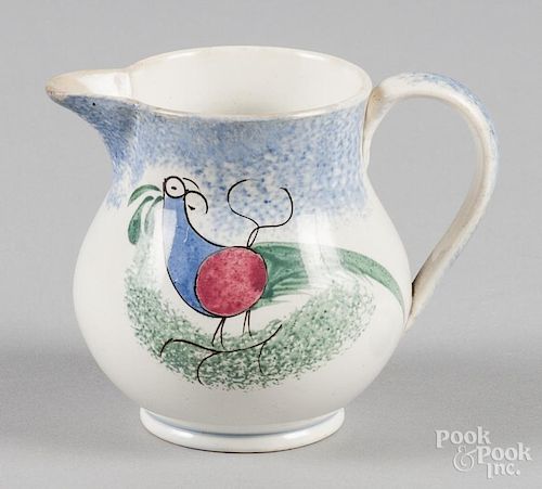 Blue spatter creamer with teal peafowl decoration, 4 1/8'' h.