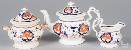 Gaudy ironstone, to include a teapot, 7'' h., a sugar, and a creamer, 19th c.