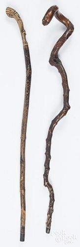 Two carved canes, early 20th c., one with a Native American in a headdress on the grip, 37'' l.