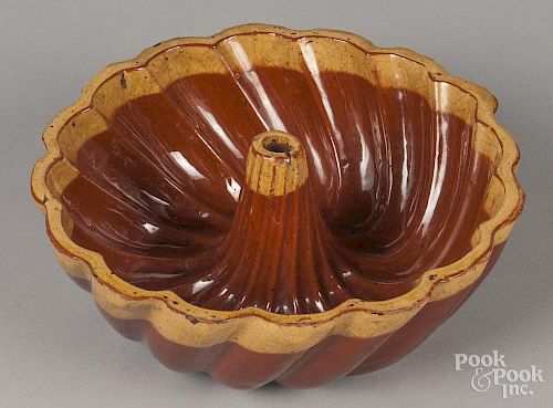 Redware mold, 19th c., with a yellow glaze rim, 3 1/4'' h., 9 1/2'' w.