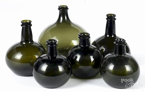 Six contemporary olive glass bottles, tallest - 8 1/4''.