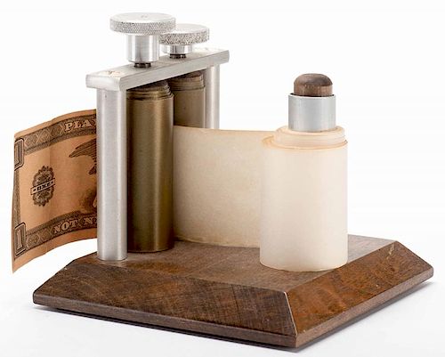 Money Maker. North Hollywood: Merv Taylor, ca. 1950. Blank paper rolled through this device turns into real currency. Wooden base with metal rollers a