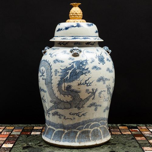 Pair of Chinese Blue and White Porcelain Jars with Later Gold-Painted Metal Pineapple Finials
