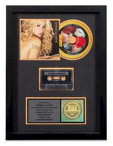 A Shakira: Laundry Service RIAA Certified Platinum Presentation Album 16 1/4 x 12 1/4 inches.