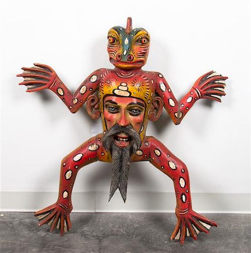* A Mexican Painted Wood Figural Mask Height 37 inches.