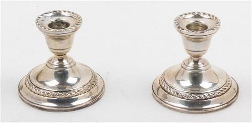 A Pair of American Silver Candlesticks, , with gadrooned borders and weighted bases.