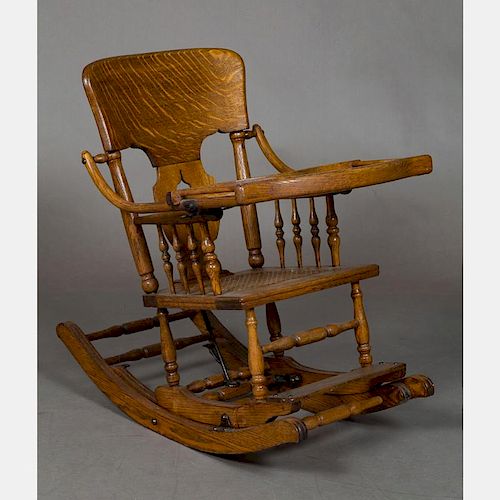 A Victorian Oak Transforming High Chair and Rocking Chair, 19th Century.