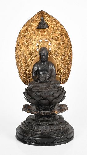 Japanese parcel gilt and ebonized seated Buddha