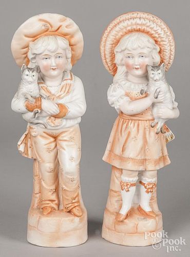 Pair of bisque figures of a boy and girl holding cats, 11 1/2'' h.