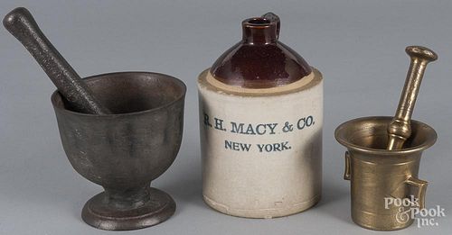 Two mortar and pestles, 19th c., together with a New York stoneware advertising jug, 8 1/2'' h.