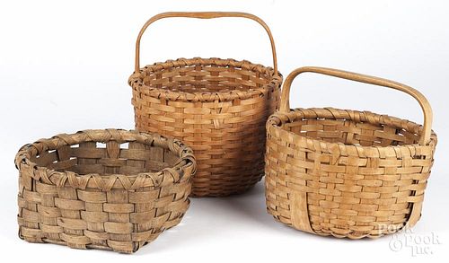 Three split oak baskets, largest - 10 1/2'' h., 9'' w.