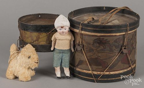 Two stenciled tin drums, largest - 7 1/4'' h., 9'' w., together with a chalk doll and a stuffed dog.
