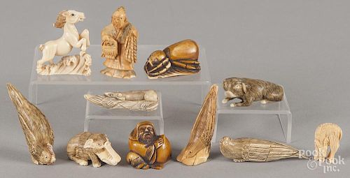 Eleven Japanese carved ivory and composition netsukes.