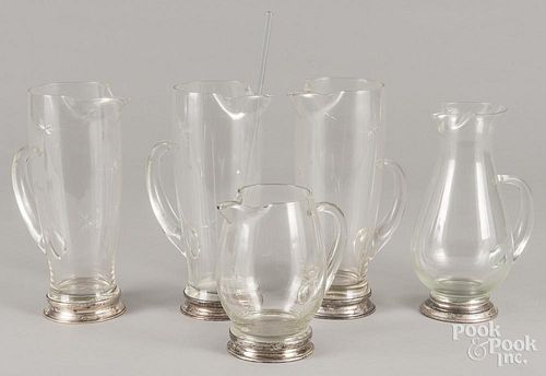 Five sterling silver mounted glass pitchers, tallest - 9 3/4''.