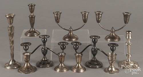Twelve sterling silver weighted candlesticks and candelabra, tallest - 10 1/4''.