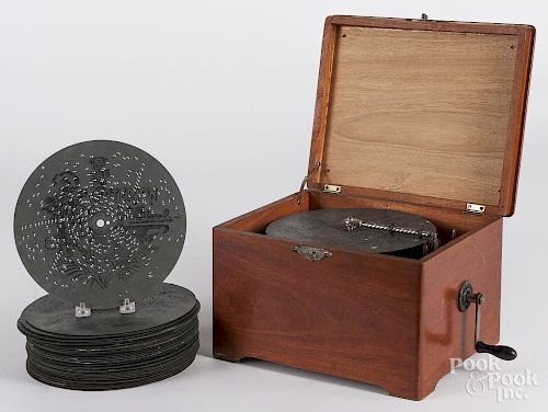 Disc music box, late 19th c., with a mahogany case, 8 1/4'' h., 11 3/4'' w.