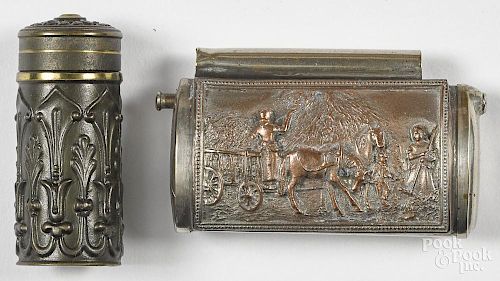 Two match vesta safes, to include a nickel silver example with an embossed hay wagon scene, 3'' l.