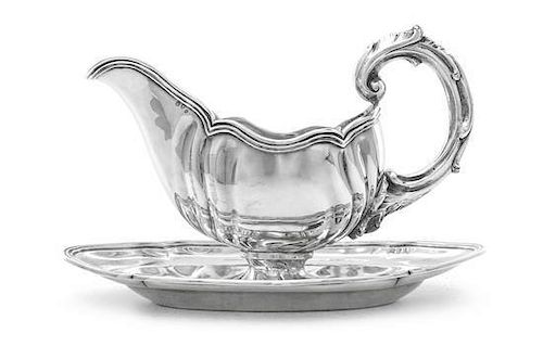 A Danish Silver Sauce Boat and Stand, Anton Michelsen, Copenhagen, 1918, the sauce bowl with lobed sides and reeded border, leaf