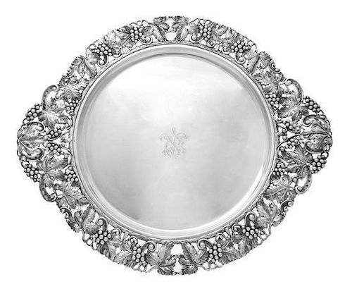 A Spanish Silver Tray, Circa 1935, circular with openwork silver grapevine border and handles, the center engraved with script m