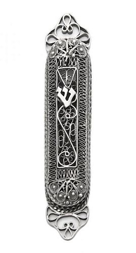An Israeli Silver Mezuzah, 20th Century, formed of bands of filigree scrolls and applied in front with a Hebrew character, fixed