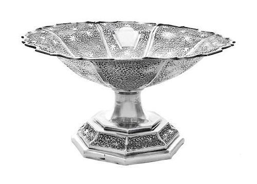 * An Indian Silver Bowl, Early 20th Century, with shaped flaring rim and densely chased with maple leaves and scrolling vines ag