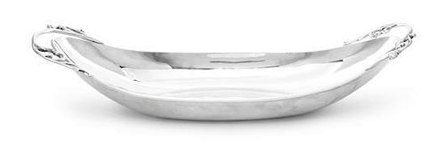 * A Mexican Silver Bread Tray, P. Lopez G., Mid 20th Century, of oval boat form, the ends applied with foliate scroll handles