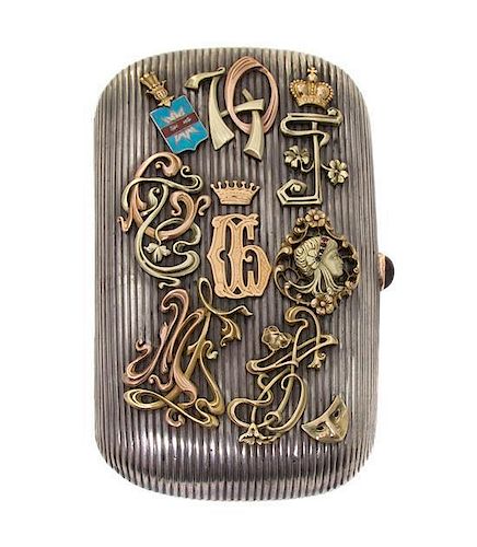A Russian Silver and Two-Color Gold Cigarette Case, Early 20th Century, of ribbed rounded rectangular form, the hinged cover mou