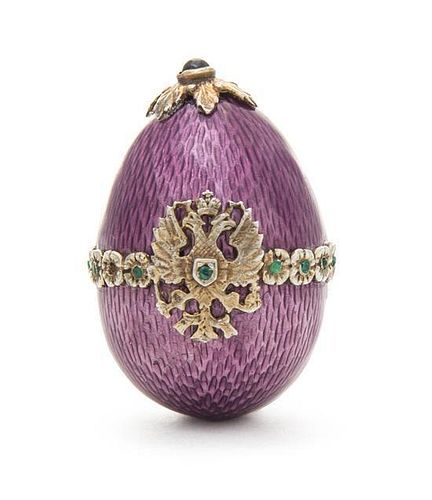 A Russian Silver and Emerald-Mounted Enamel Egg, 20th Century, the egg with purple guilloche enamel surface mounted with a band