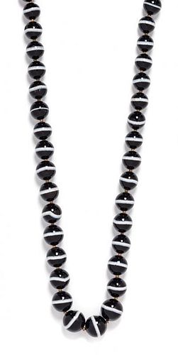 * A Single Strand Graduated Banded Onyx Bead Necklace,
