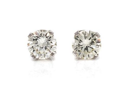 * A Pair of 18 Karat White Gold and Diamond Stud Earrings, 0.80 dwts.