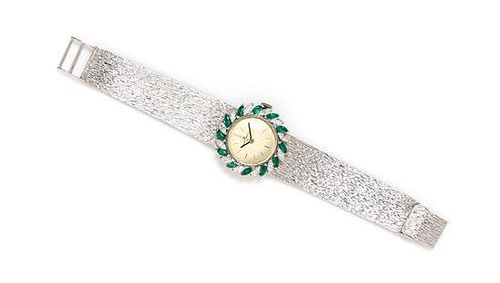 An 18 Karat White Gold, Diamond and Emerald Wristwatch, Baume & Mercier, 34.70 dwts.