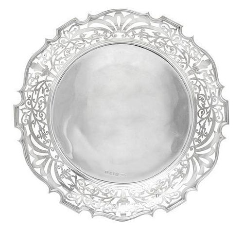 * An Edwardian Silver Dish, James Woods & Sons, Birmingham, 1910, circular, the wide upturned border pierced with scrolling foli
