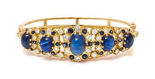 * A Yellow Gold, Sapphire and Diamond Bangle Bracelet, 25.90 dwts.