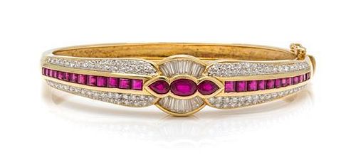 * An 18 Karat Yellow Gold, Ruby and Diamond Bangle Bracelet, 19.00 dwts.