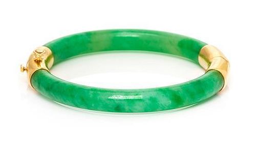 A Yellow Gold and Jadeite Jade Bangle Bracelet, 22.70 dwts.