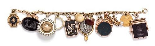 A 14 Karat Yellow Gold Charm Bracelet with 13 Attached Charms, 59.30 dwts.