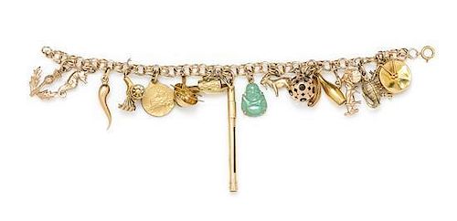 A 14 Karat Yellow Gold Charm Bracelet with 16 Attached Charms, 21.40 dwts.